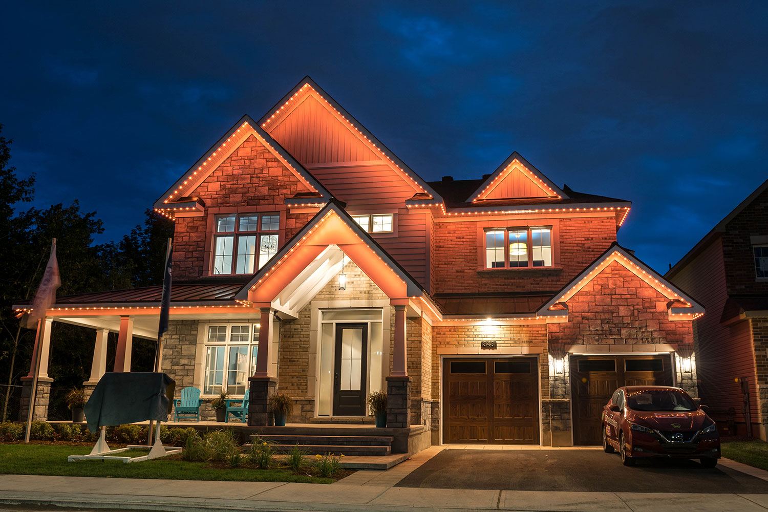 A home glowing with warm permanent lighting at dusk