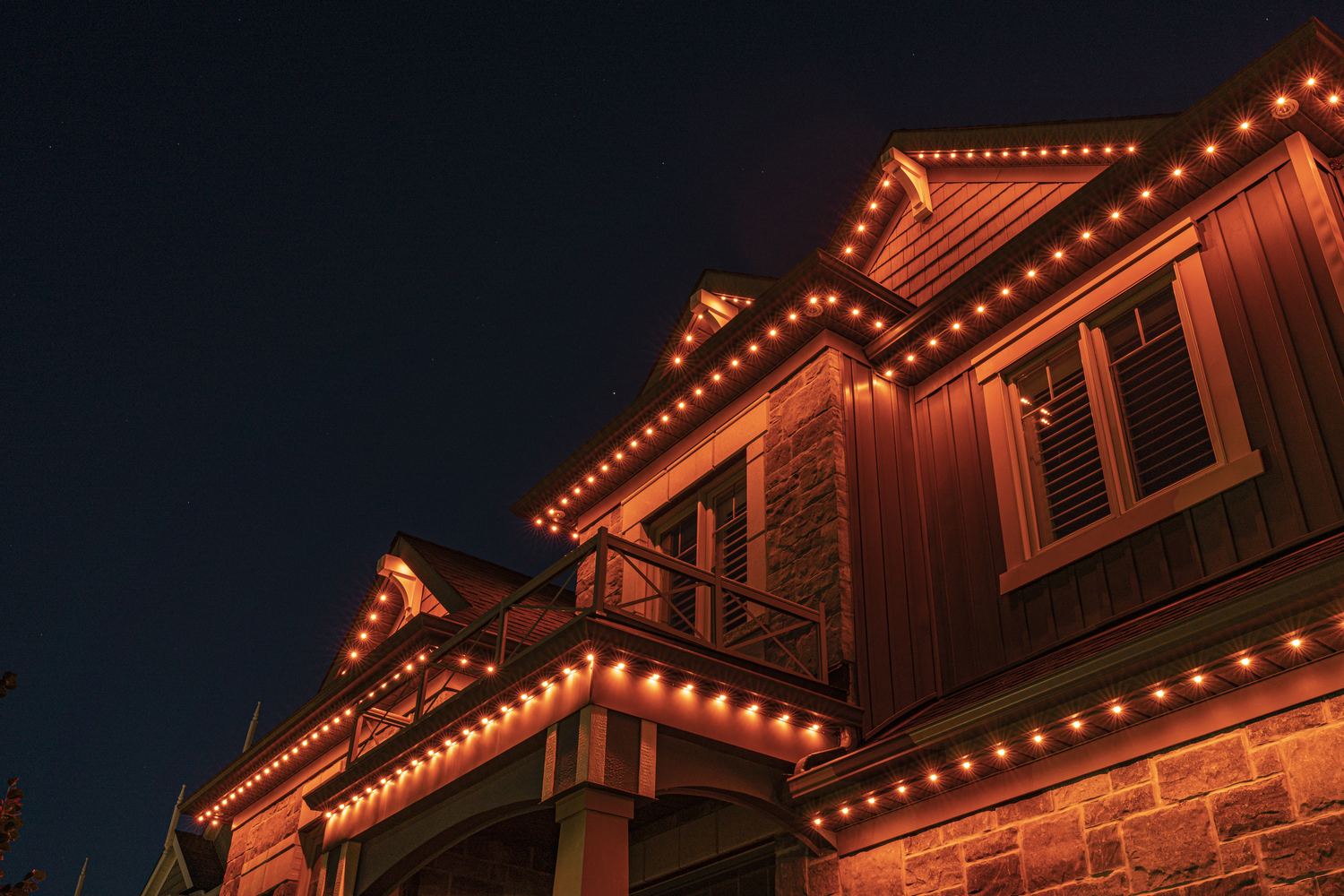 A home lit in orange permanent LED lighting for Halloween