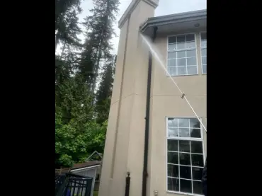 Technician pressure washing a home exterior